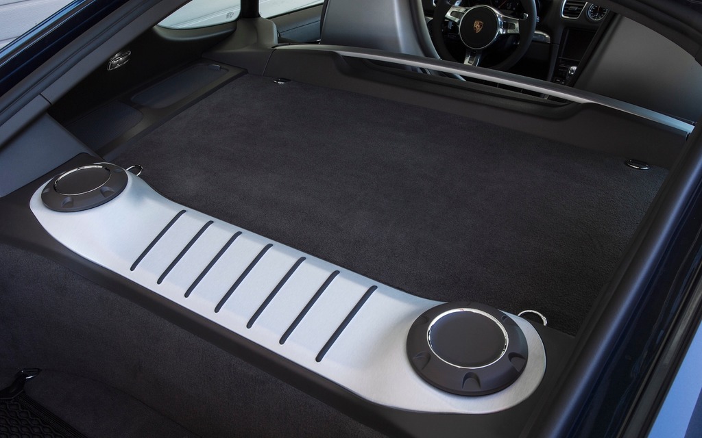 The cargo space is accessible by the rear hatch on the 2014 Porsche Cayman S. Extra space in the