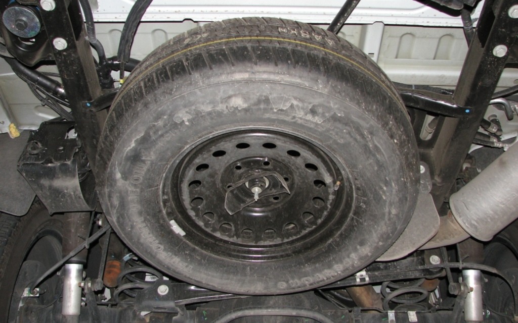 A fullsize spare tire sits under the floor of the Escalade. To remove