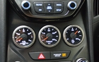 2013 Hyundai Genesis Coupe 3.8 GT. On the models equipped with the V6 engine, the centre gauge indicates torque in lbs.-ft. rather instead of displaying boost pressure, as it does on the 2.0T. The section at the top of the photo is different than the one on the 2.0T due to the GPS.