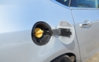 The Verano takes regular gas or E85 (15% ethanol), which is what the yellow cap is for