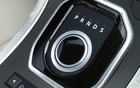 The turn-dial gear selector emerges from the console when you start the vehicle.