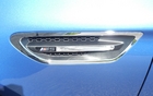 This chrome intake breaks the lateral lines.