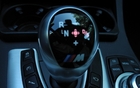 The stickshift is surrounded by control pads mounted on the console.