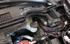 Fortunately, there are access points to reach the mechanical components hidden under the windshield. We removed a plastic cover to access the brake fluid. 