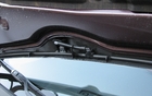 The windshield-wiper jets are located on the hood. The pipes that run along the bottom of the hood have been very well installed. 