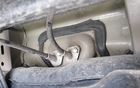 This is where the brake cables enter the vehicle’s interior. They are well fixed and effective, but not well protected. 