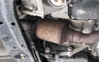 A small catalytic converter located on the engine exhaust works to burn off fumes. But it looks as though it may already be rusty. 