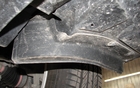  This plastic cover protects tires from debris coming off the road. It also acts as an air diffuser.