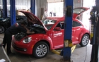 As soon as it rolled into the garage, the Beetle was subject to our mechanic’s careful examination. He started by removing the plastic engine cover.