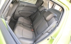 The back seats offer good leg and head room. In the middle, there’s a cupholder and a storage compartment.