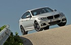 Superbe photo 3/4 avant de la BMW Série 3 Gran Turismo 2014 sur une route de Sicile